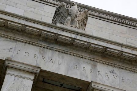 An eagle tops the U.S. Federal Reserve building's facade in Washington, July 31, 2013. The U.S. Federal Reserve likely will decide at the end of a policy meeting on Wednesday to continue buying bonds at an $85 billion monthly pace, but it could alter an accompanying statement to spell out the possibility of scaling back purchases later this year. REUTERS/Jonathan Ernst (UNITED STATES - Tags: POLITICS BUSINESS)