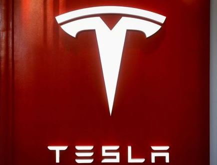 The Tesla logo is seen at the entrance to Tesla Motors' showroom in Manhattan's Meatpacking District in New York City, U.S., December 14, 2017. REUTERS/Brendan McDermid/File Photo