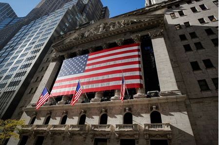 The U.S. flag covers the front facade of the New York Stock Exchange (NYSE) in New York City, New York, U.S., November 9, 2020. REUTERS/Brendan McDermid