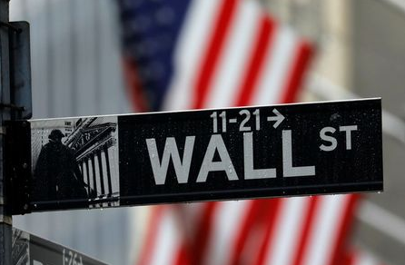 Raindrops hang on a sign for Wall Street outside the New York Stock Exchange in Manhattan in New York City, New York, U.S., October 26, 2020. REUTERS/Mike Segar
