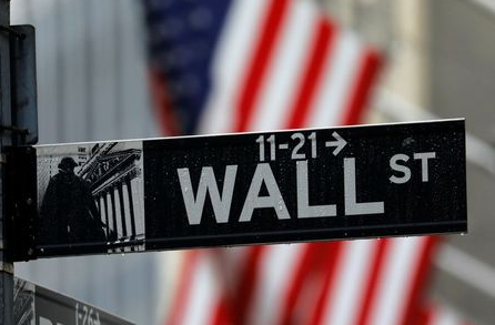 Raindrops hang on a sign for Wall Street outside the New York Stock Exchange in Manhattan in New York City, New York, U.S., October 26, 2020. REUTERS/Mike Segar