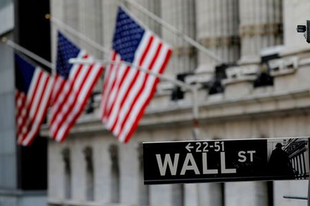 FILE PHOTO: American flags hang from the facade of the New York Stock Exchange (NYSE) building after the start of Thursda's trading session in Manhattan in New York City, New York, U.S., January 28, 2021. REUTERS/Mike Segar/File Photo