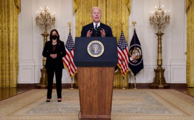 U.S. President Joe Biden delivers remarks about his Build Back Better agenda and the bipartisan infrastructure deal as Vice President Kamala Harris stands by in the East Room of the White House in Washington, U.S., October 28, 2021. REUTERS/Jonathan Ernst