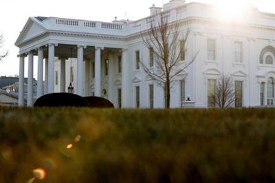 A general view of the sun rising behind the White House in Washington, U.S. January 22, 2021. REUTERS/Jonathan Ernst