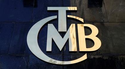 FILE PHOTO: A logo of Turkey's Central Bank (TCMB) is pictured at the entrance of the bank's headquarters in Ankara, Turkey April 19, 2015. REUTERS/Umit Bektas/File Photo 