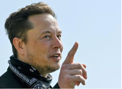 FILE PHOTO: Tesla CEO Elon Musk gestures as he visits the construction site of Tesla's Gigafactory in Gruenheide near Berlin, Germany, August 13, 2021. Patrick Pleul/Pool via Reuters